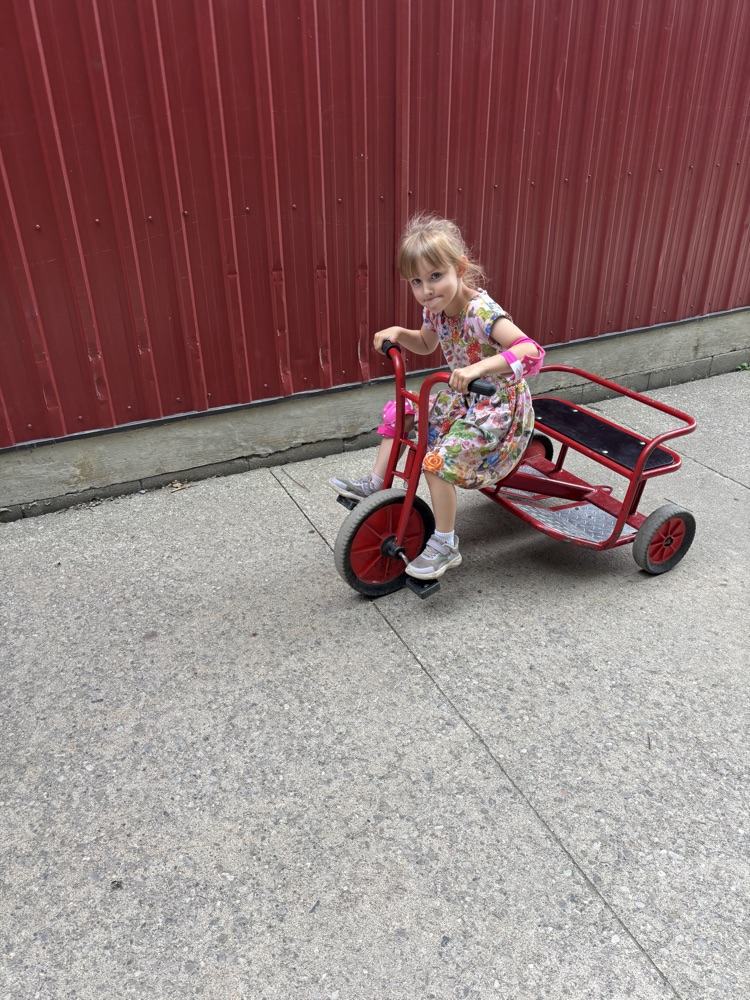 Student riding a tricycle