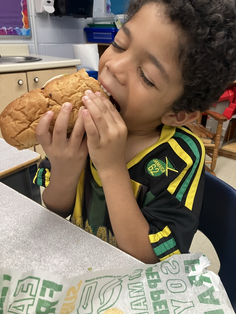 student eating a sub