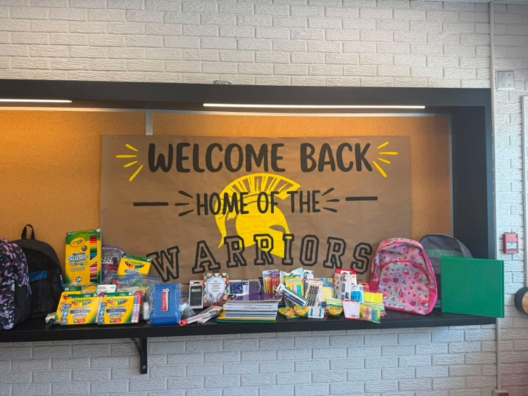 a collection of back to school supplies sitting on a shelf with a banner behind saying welcome Back Warriors