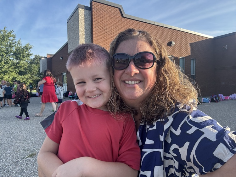 young male student smiling at the camera with Mrs V