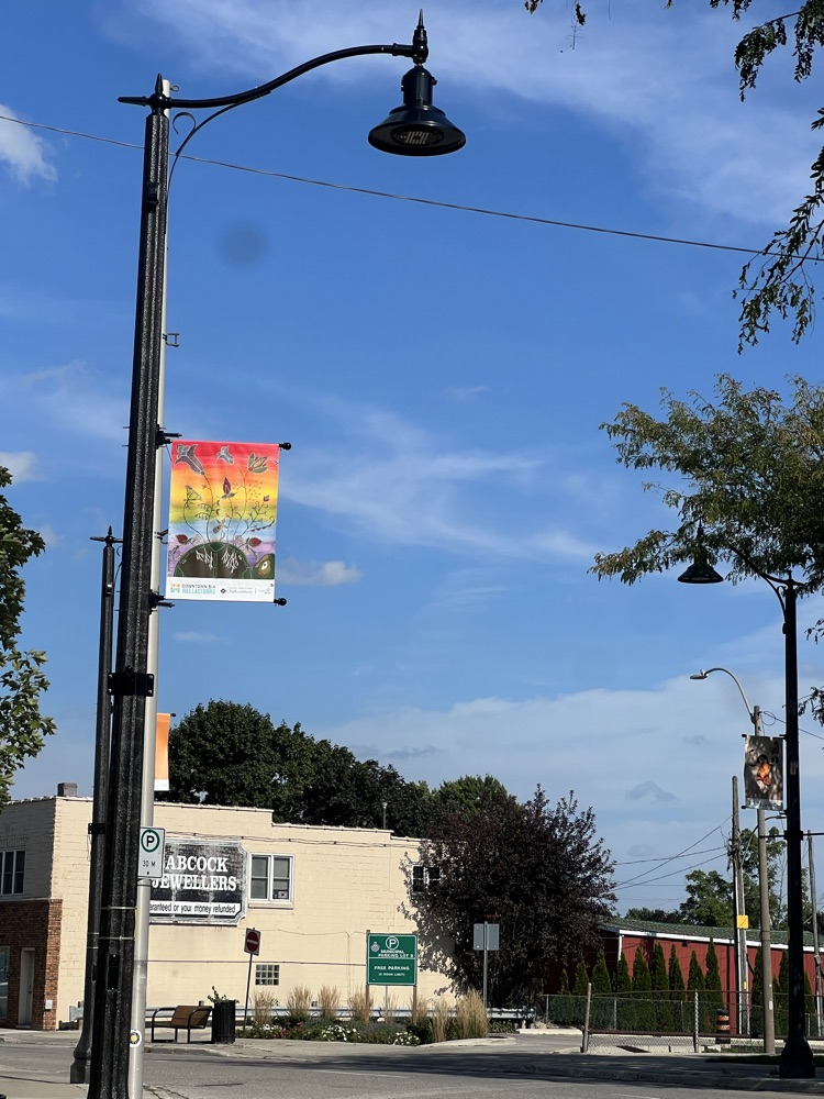 A banner hung from a light post 