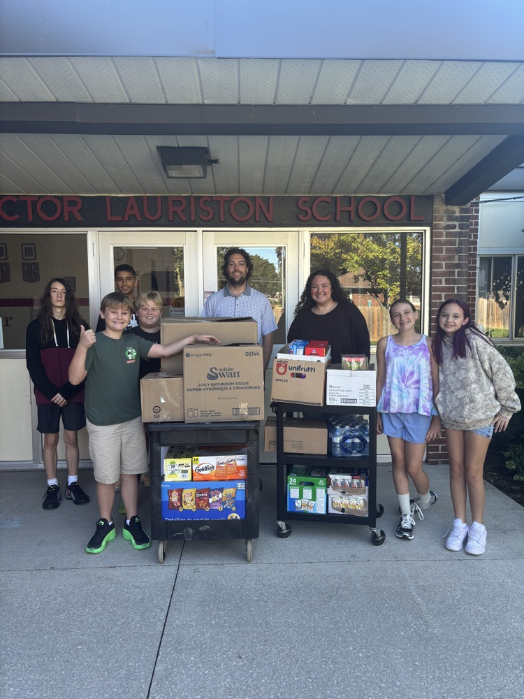 Group of students gathering around two carts full of food