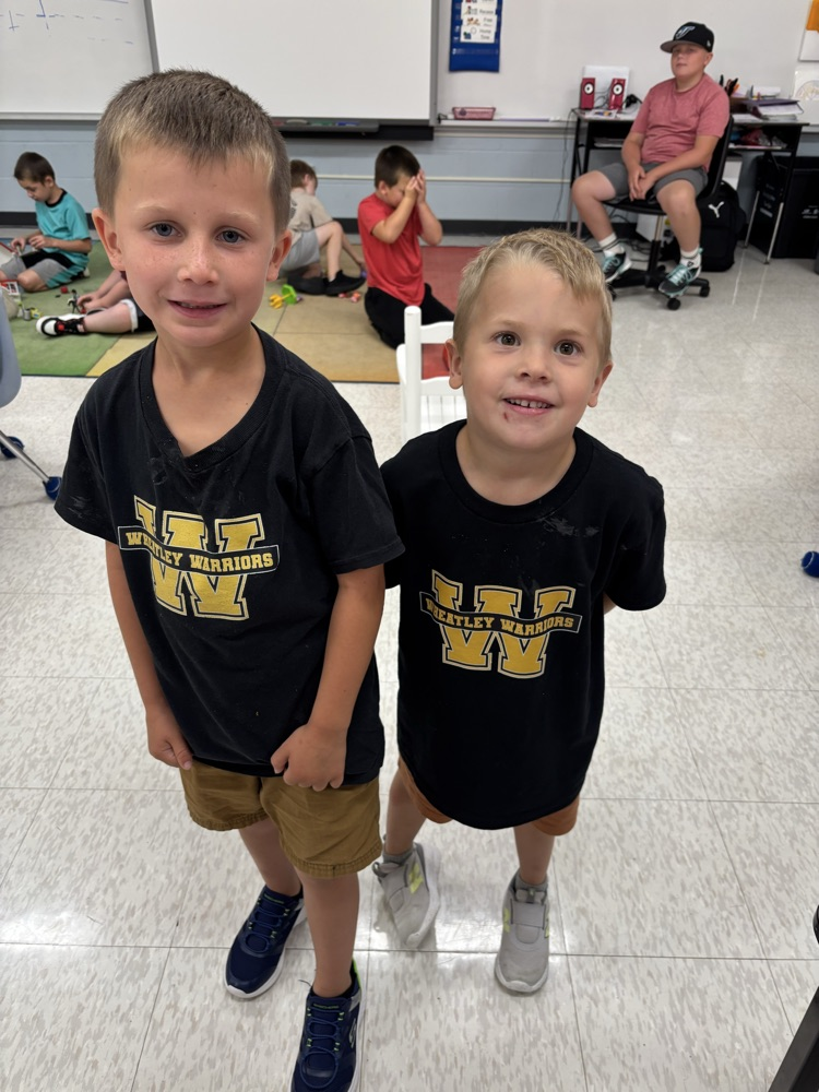 2 students smiling for the camera in their Warrior shirts