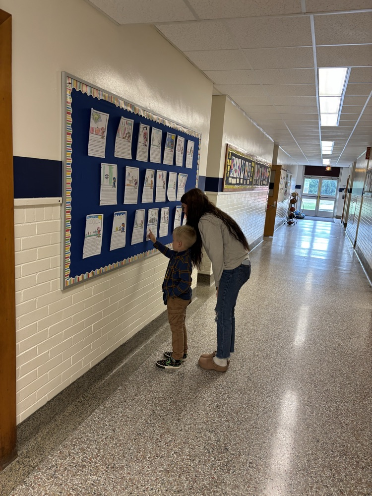student showing their work to their parent