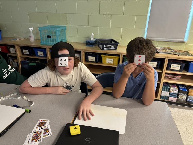 two boys playing a math card game