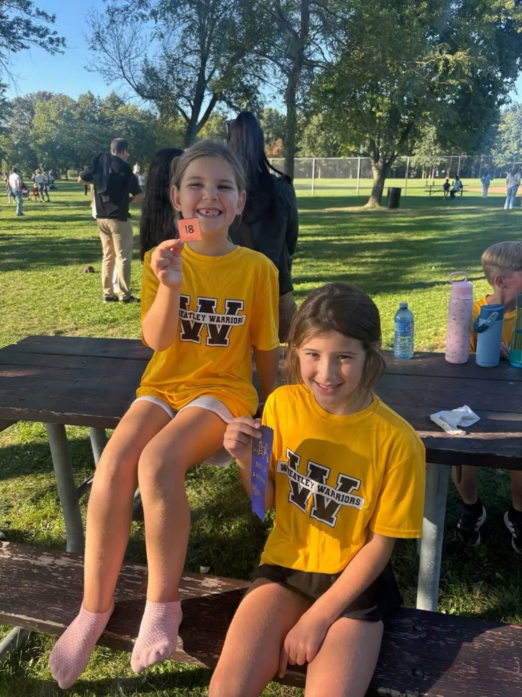 too young female runners, holding their ribbons after their cross-country run