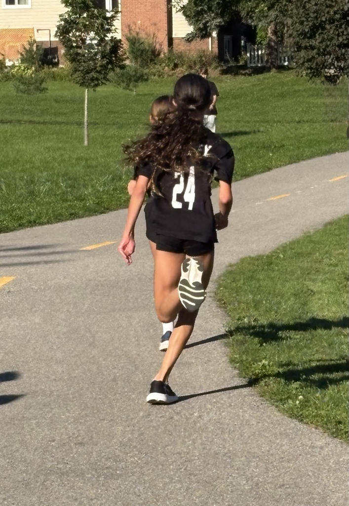 A young girl running down the path at Mud Creek.