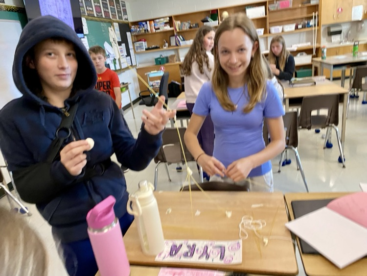students building a structure with spaghetti and marshmallows 