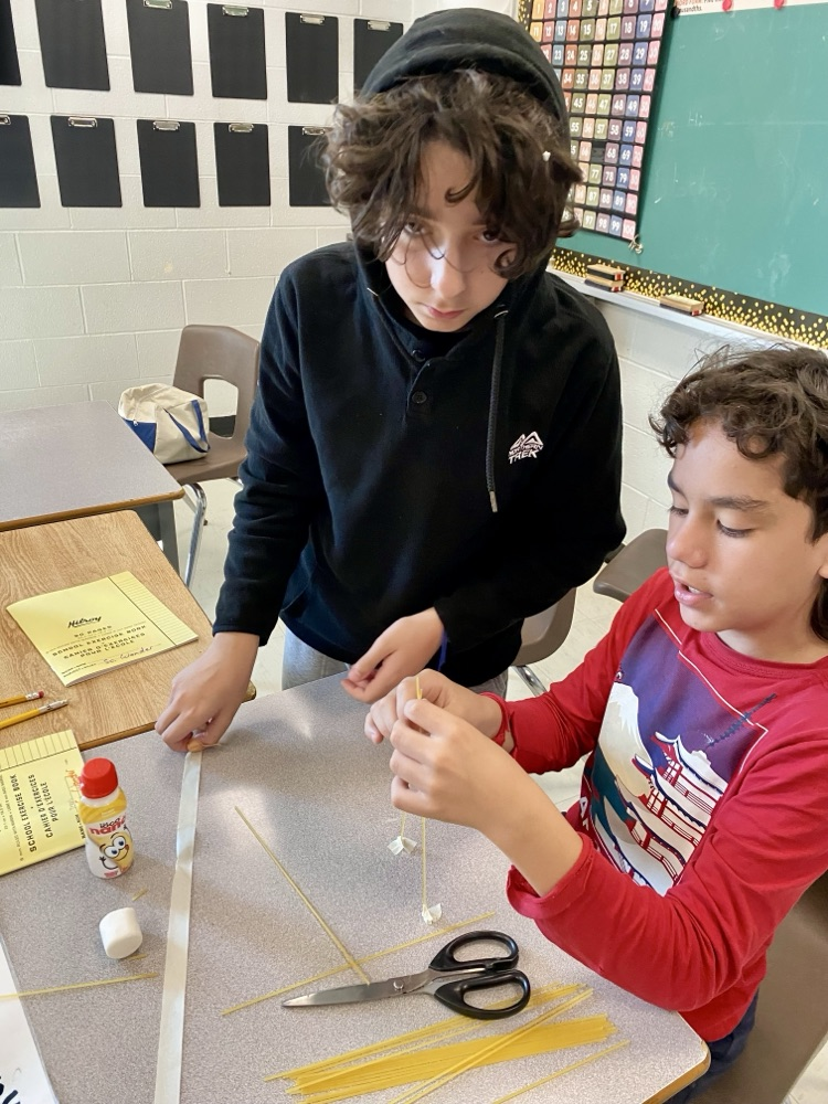 students building a structure with spaghetti and marshmallows