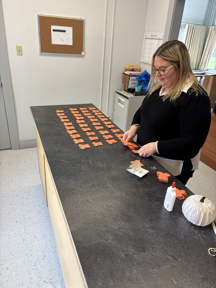 assembling orange shirt pins for all students and staff