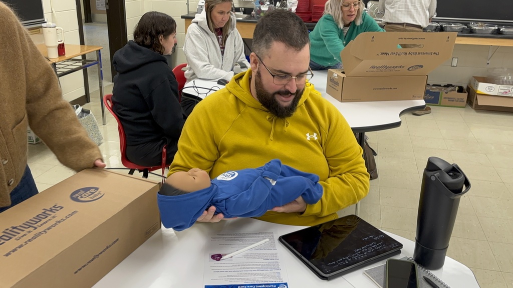 LKDSB staff holding baby simulator during training 