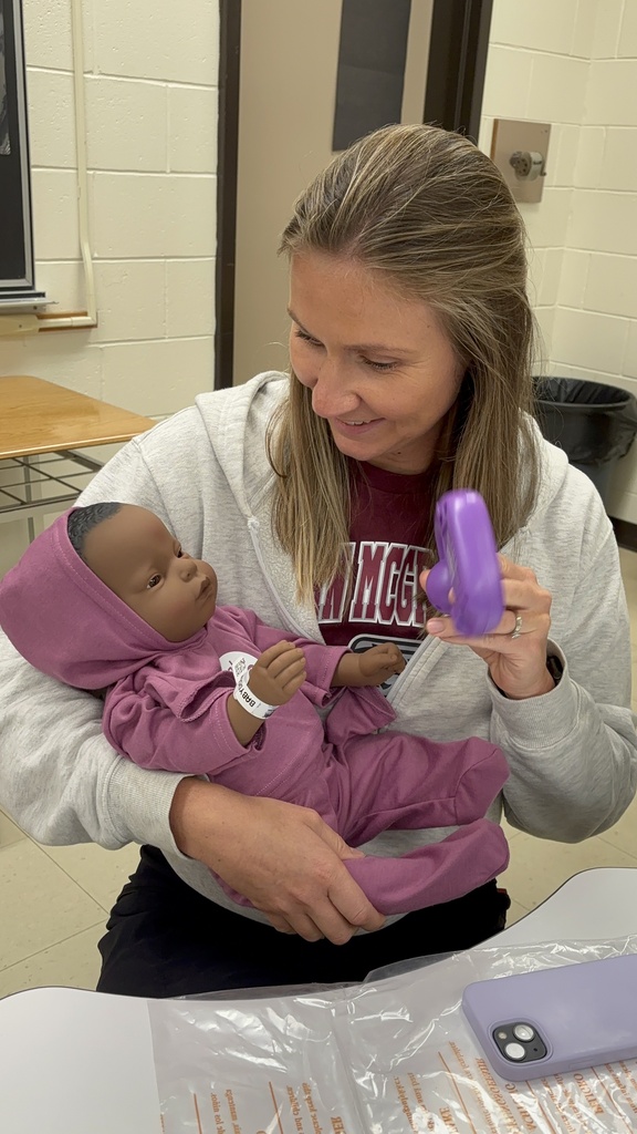 LKDSB staff holding baby simulator during training 