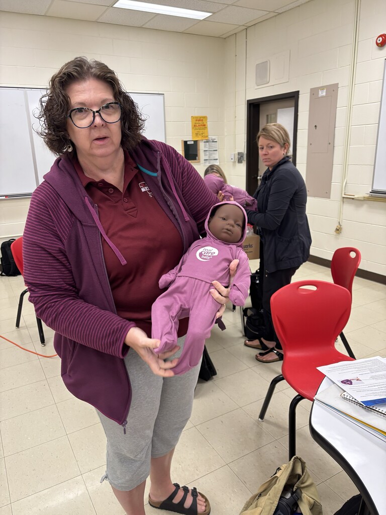 LKDSB staff holding baby simulator during training 