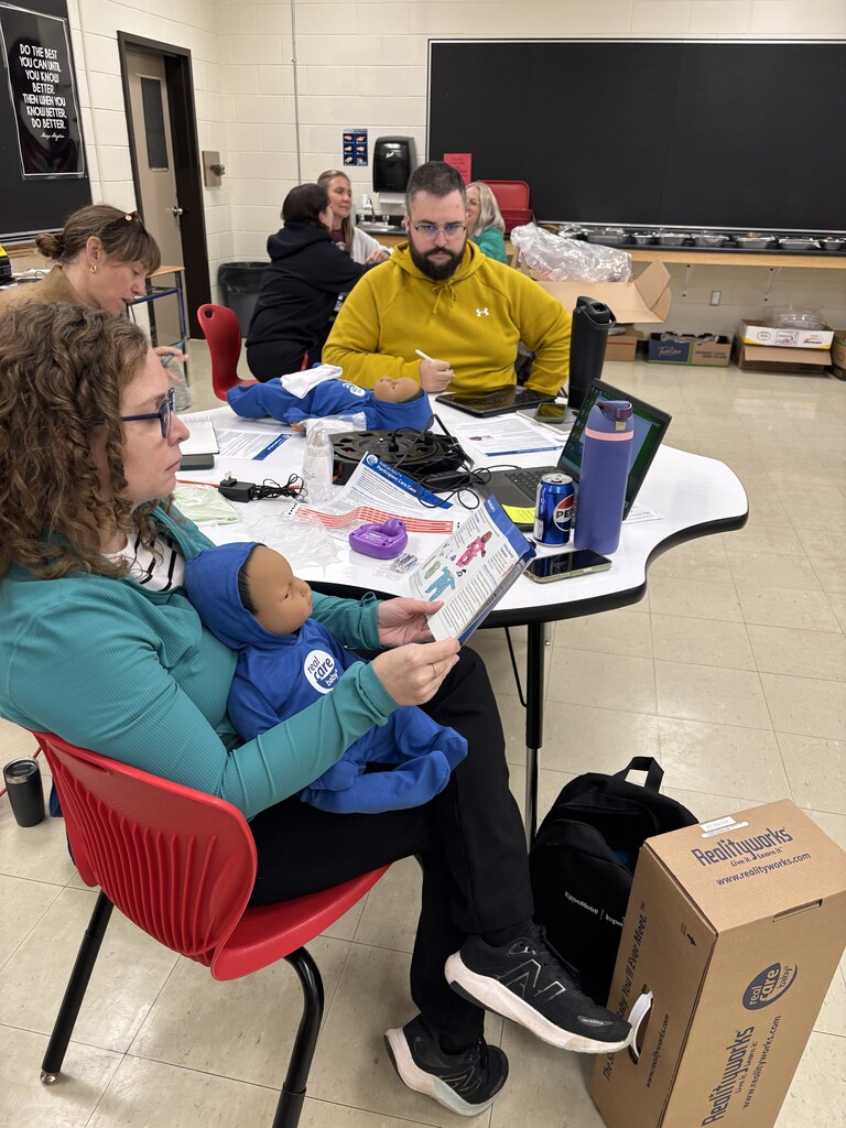 LKDSB staff holding baby simulator during training 