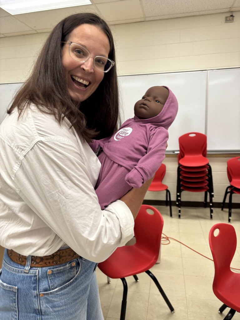 LKDSB staff holding baby simulator during training 