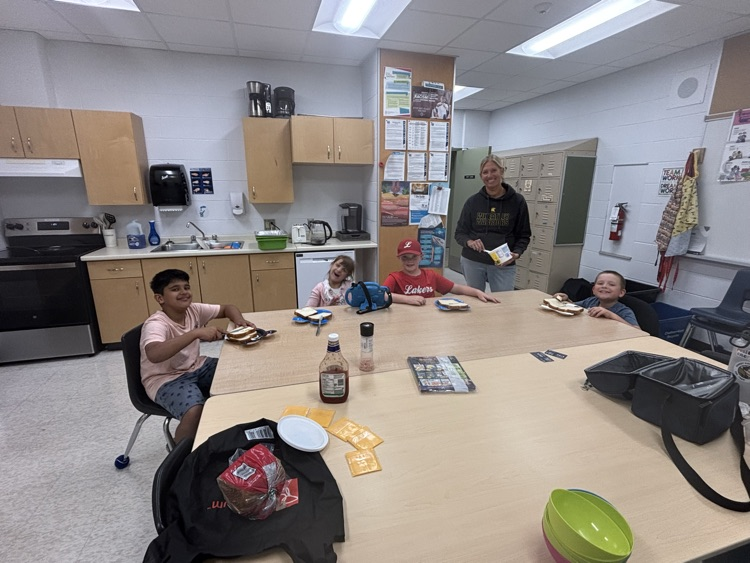 4 students learning to make their procedural writing more clear sitting at a table making a sandwich