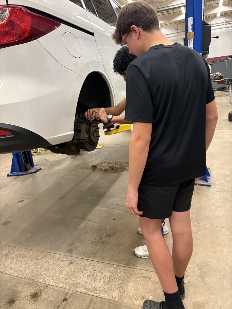 Two students working on car
