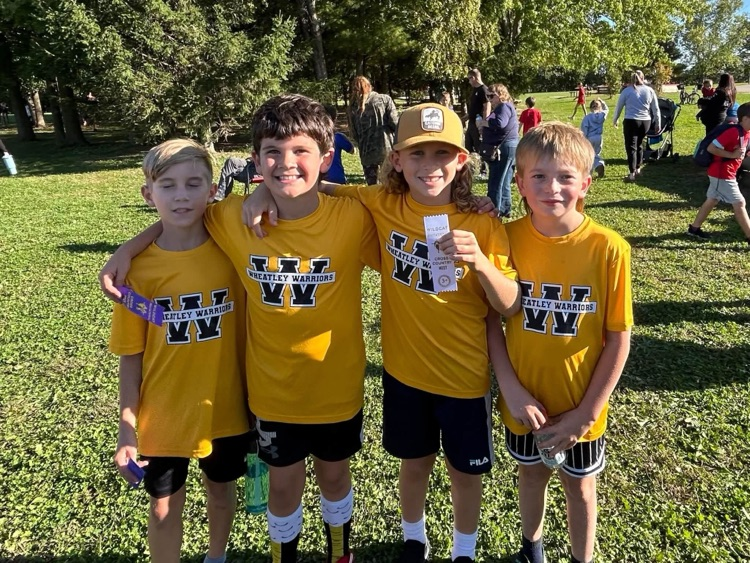 A small group of cross-country runners with their ribbons
