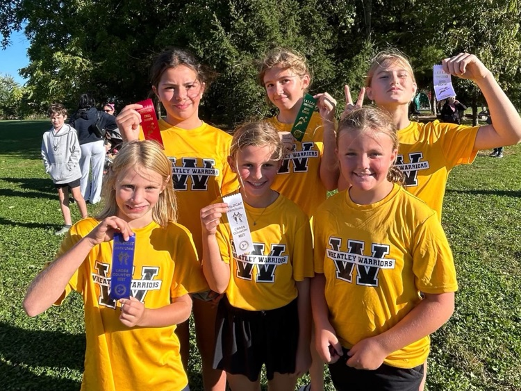 A small group of cross-country runners with the ribbons