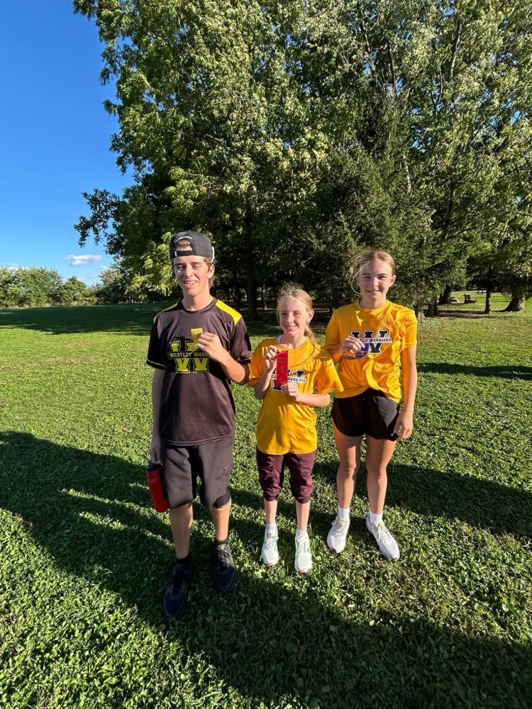 A small group of cross country runners with the ribbons