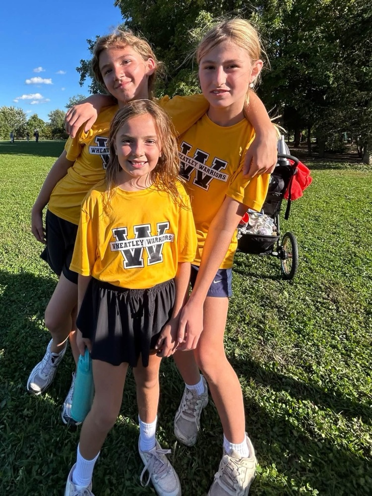A small group of cross-country runners with their ribbons