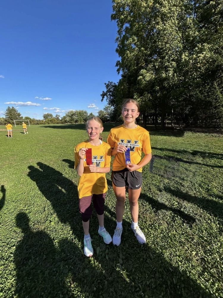 Two cross-country runners with their ribbons
