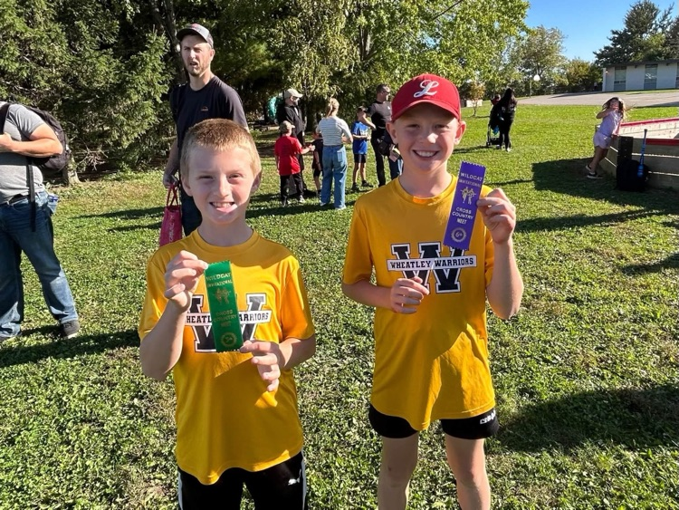 Two cross country runners with their ribbons