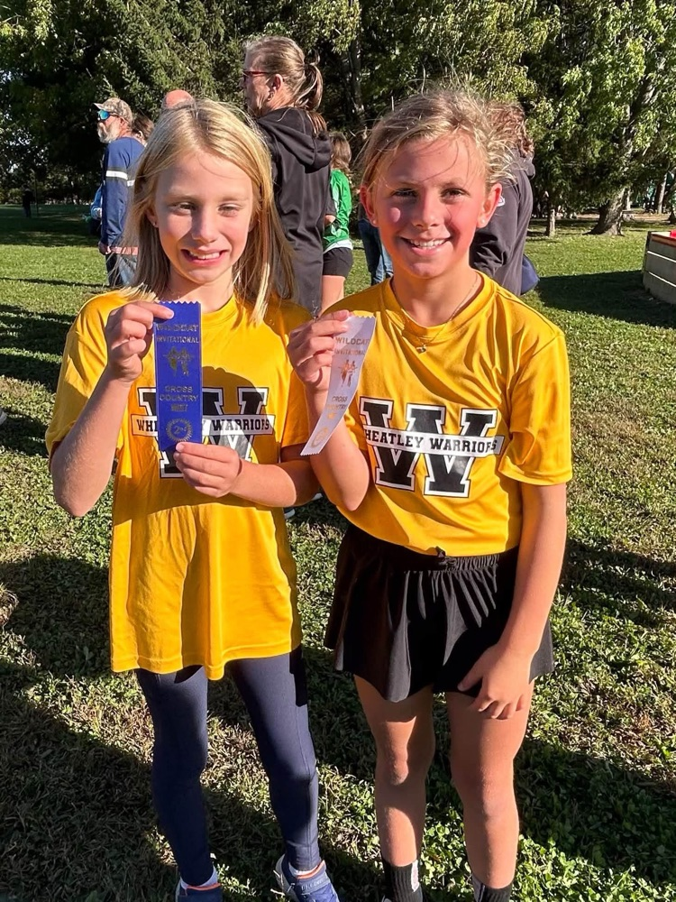 Two cross country runners with their ribbon