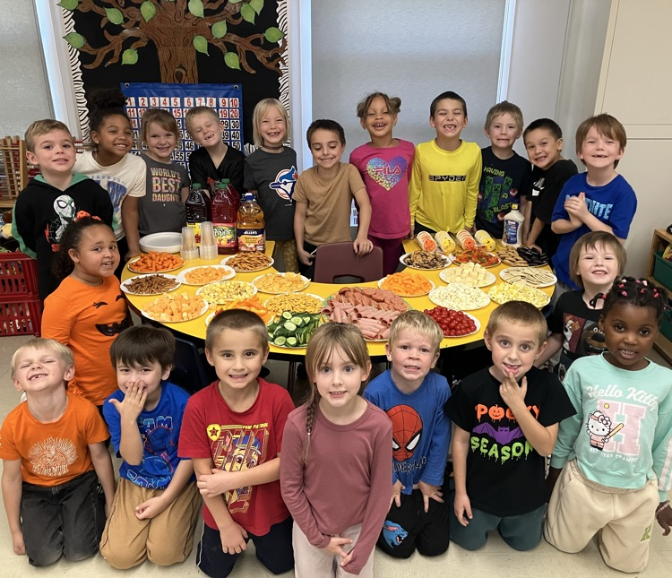 students sitting around a table of food at Thanksgiving