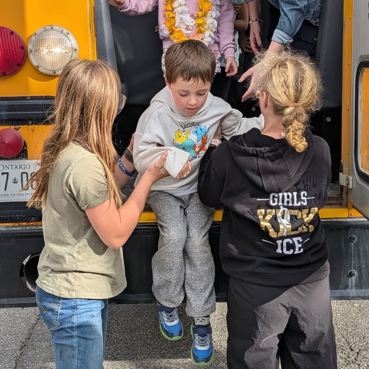 students practicing bus evacuation through emergency exit