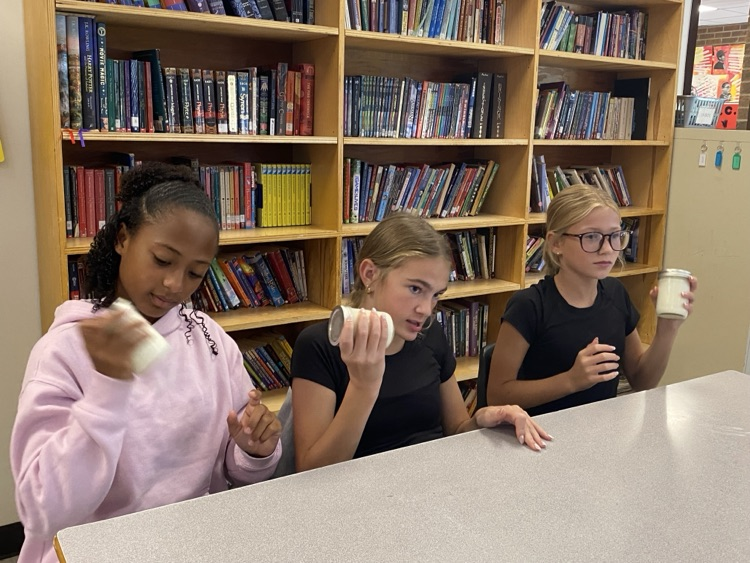 Students shaking their jars to make butter.
