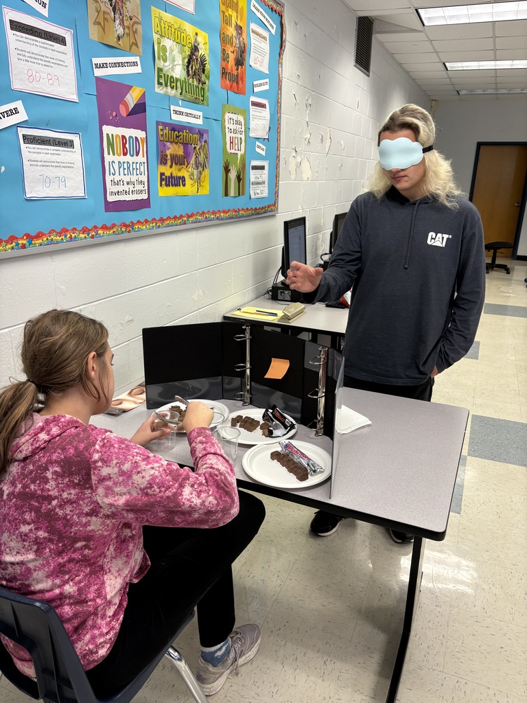 Students taste testing Mars, 3 Musketeers, and Meteor bars!