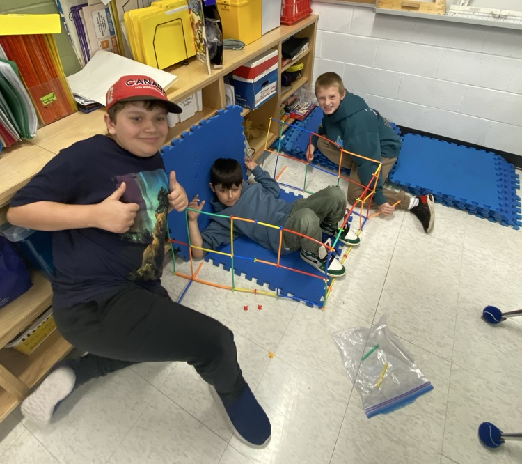 3 boys using straws and connectors in the build a house challenge 