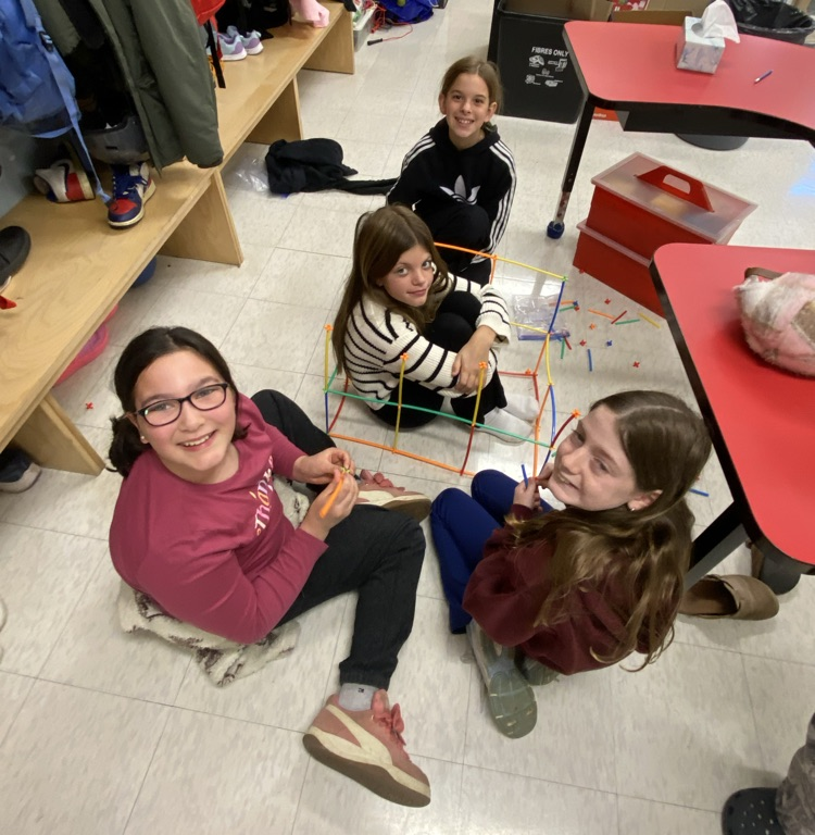 students using straws and connectors in the build a house challenge 