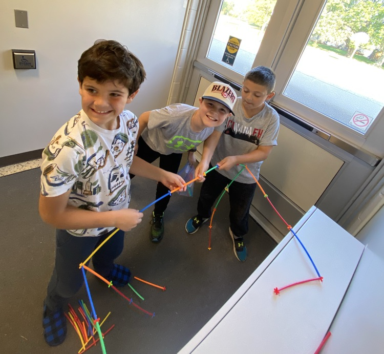 3 boys using straws and connectors in the build a house challenge 