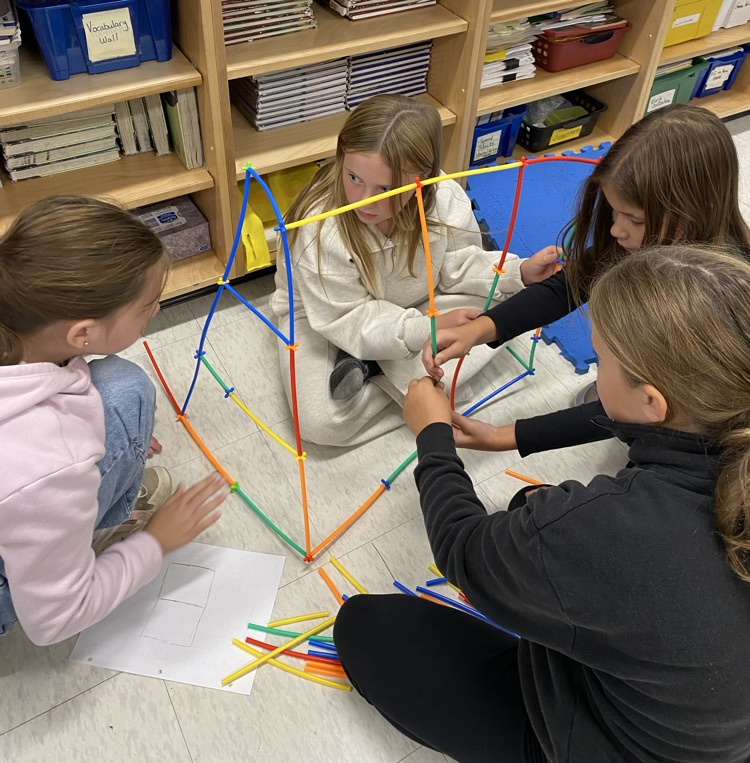 4 girls using straws and connectors in the build a house challenge 