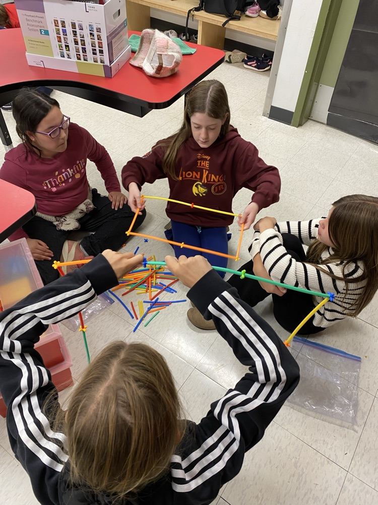 4 girls using straws and connectors in the build a house challenge