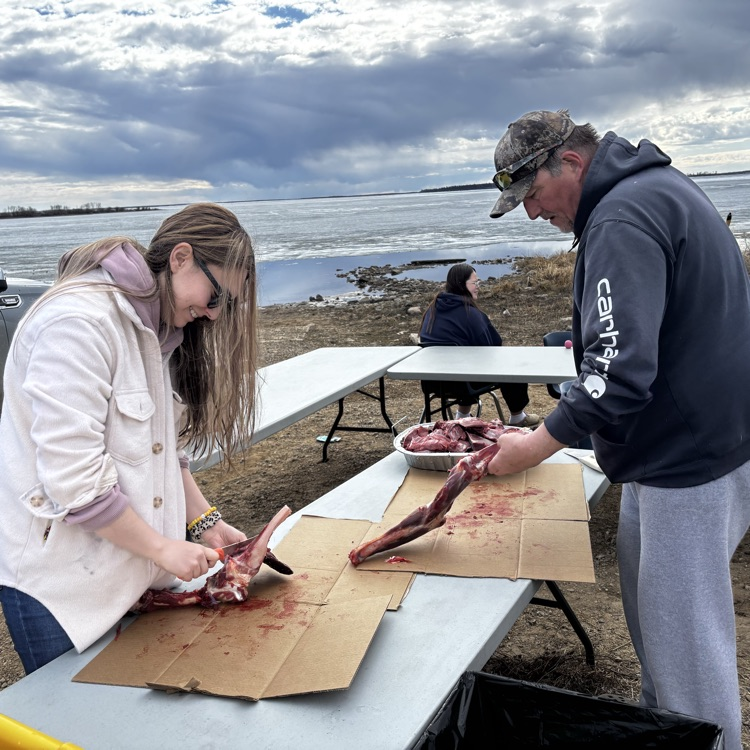 Bill & Lindsay Graham cutting moose meat