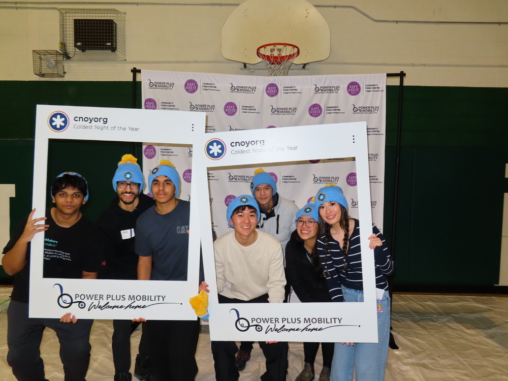 Students at GCVI Coldest Night of the Year event posing for a picture in a mock polaroid frame