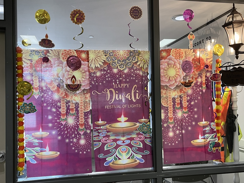 Happy Diwali display (large purple flag with flowers and lamps)