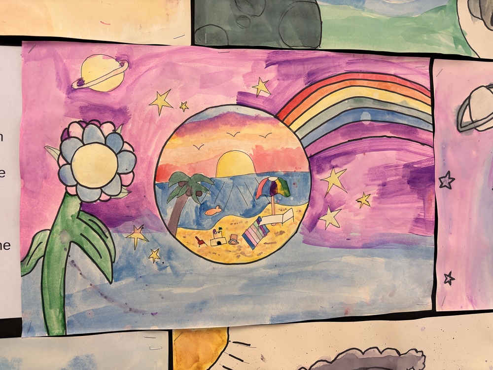 Water colour art with a large blue flower, purple sky with planet and rainbow, with a circle in the middle with  beach scene