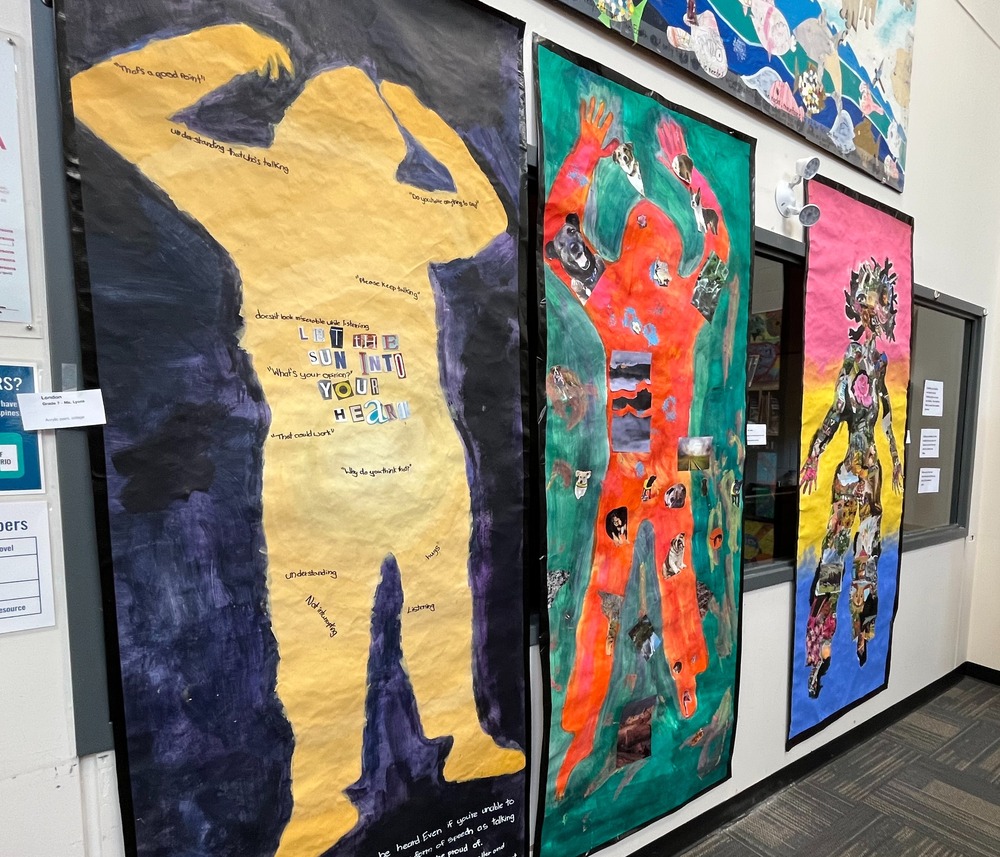 Three pieces of art with bold colours or human forms (life size) that have words and magazine photos on them demonstrating sself expression and goals.