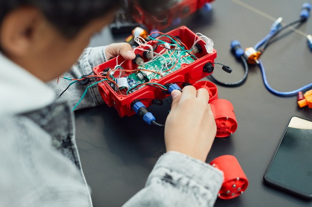 Close up image of a student working on a robotics project.
