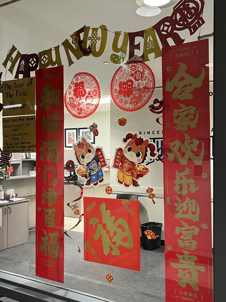 Happy New Year display; 2 cartoomn horses, with red and gold symbols and decorations