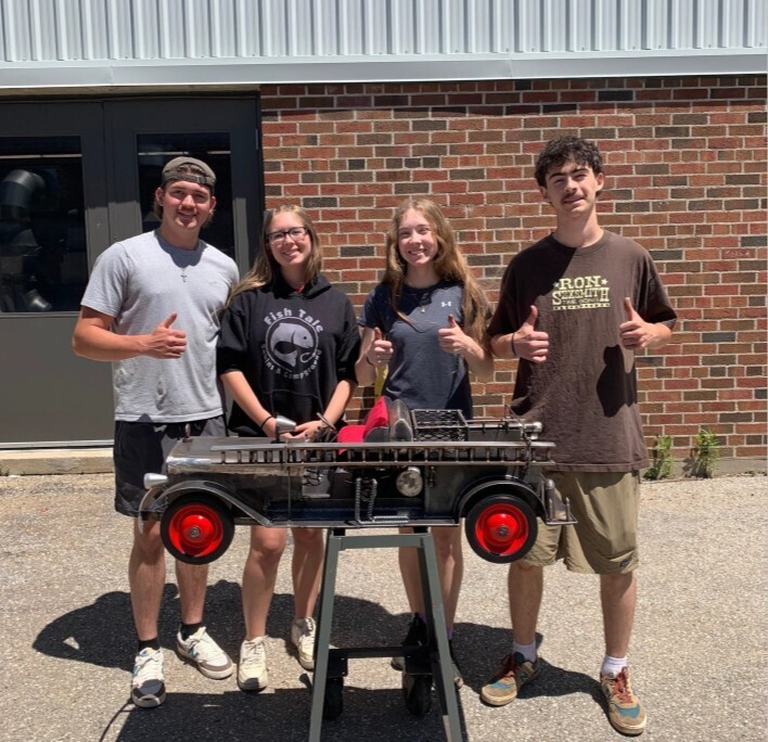 A photo of four ODSS students with their Bickle replica