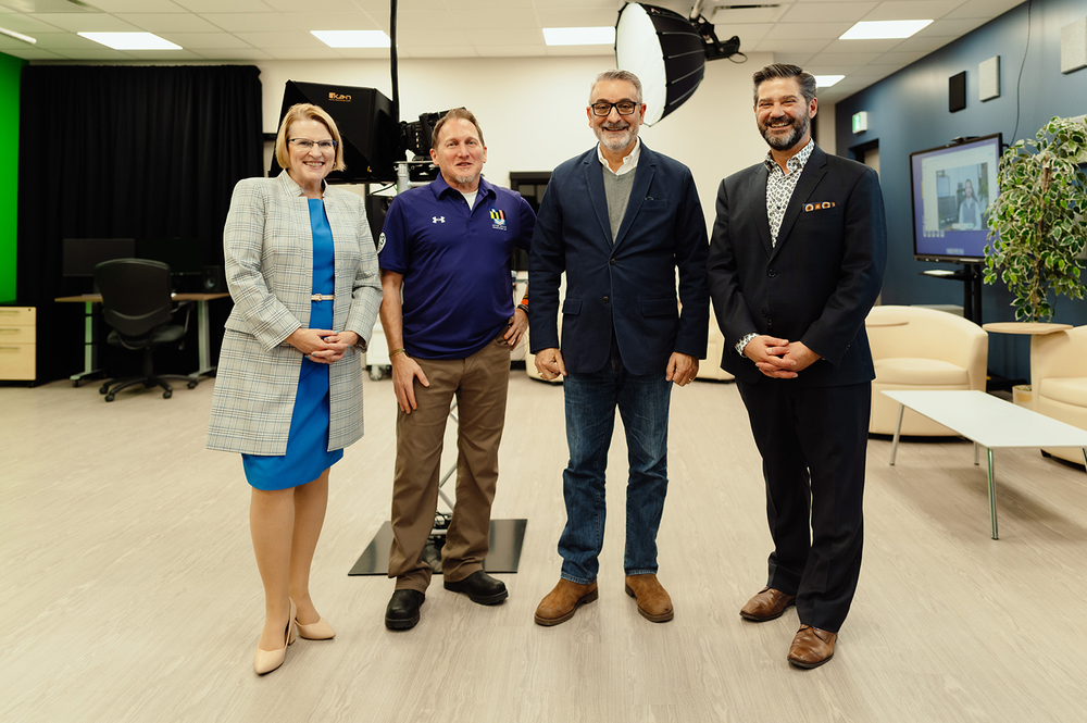 Four people pose for a photo.