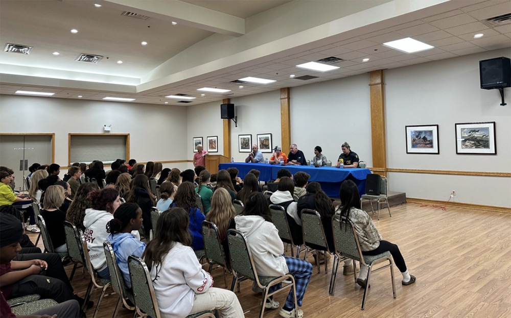 Students sit in a conference room at a career event.