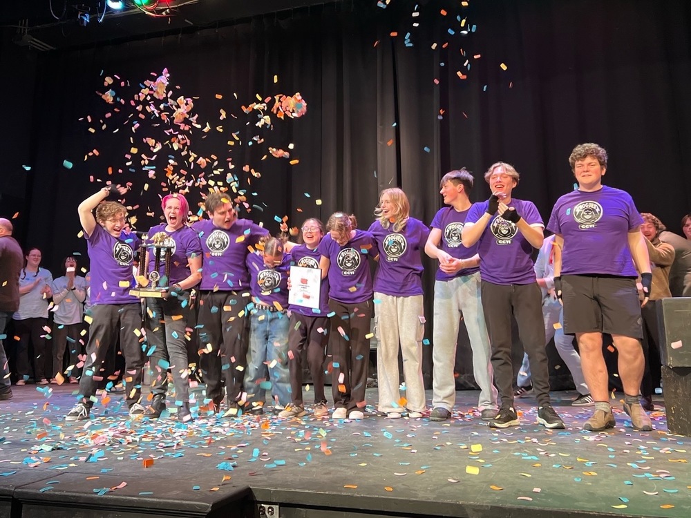 PIctured are CCVI students on stage with a trophy and confetti