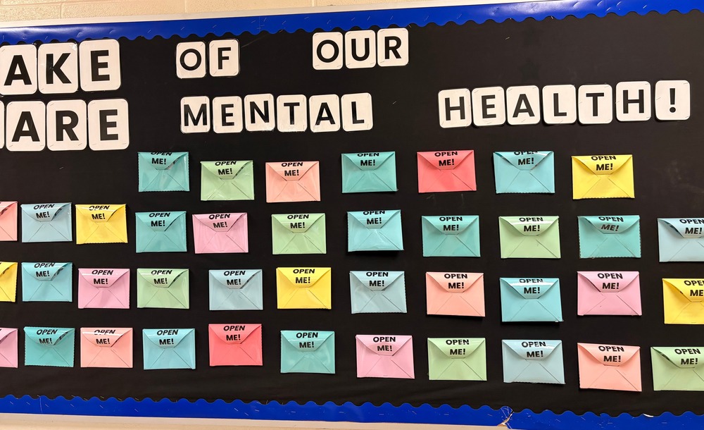 Bulletion board with colourful envel;opes about taking care of our mental health.
