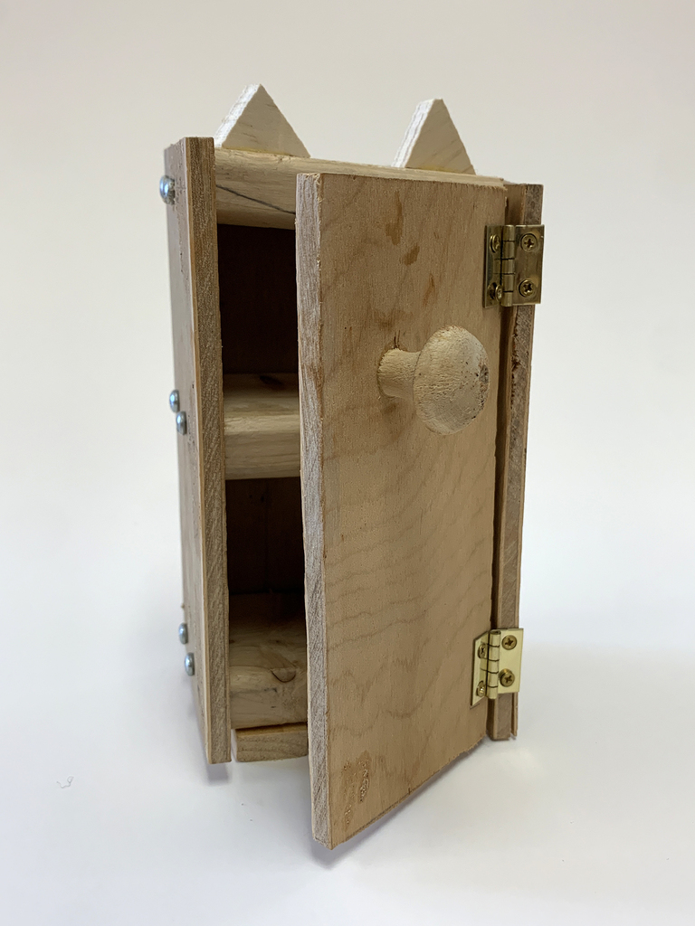 A toy fridge made from scrap materials.